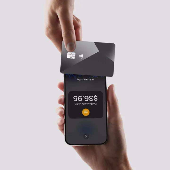 A customer holds a card over the top of an iPhone showing an amount to pay.